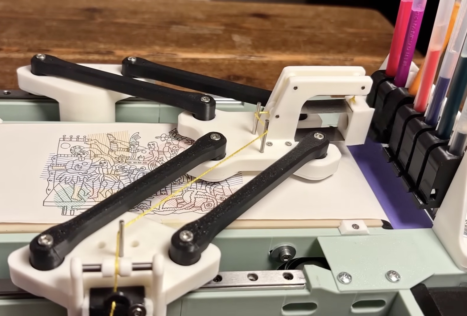 This DIY pen plotter has delta kinematics and a tool changer